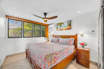 Bedroom with king bed and louvered window
