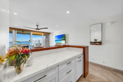 Kitchen counter beneath the window, ocean beyond