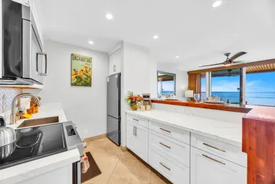 Kitchen with stainless appliances and an ocean view through the window
