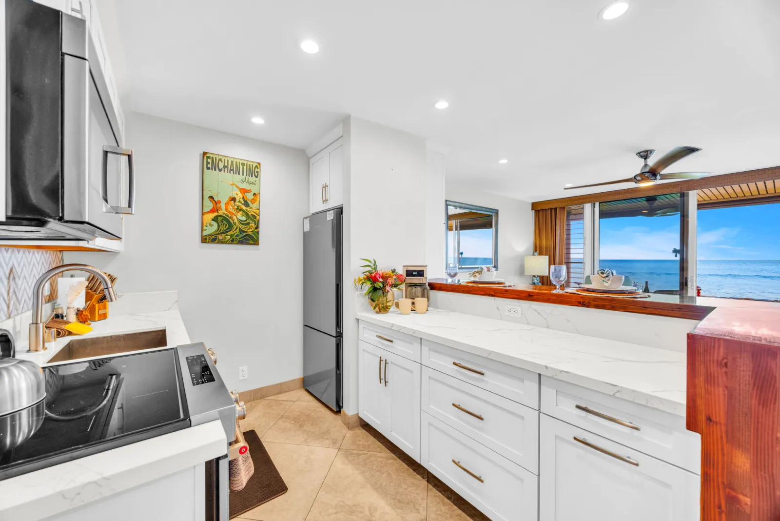 Kitchen with stainless appliances and an ocean view through the window