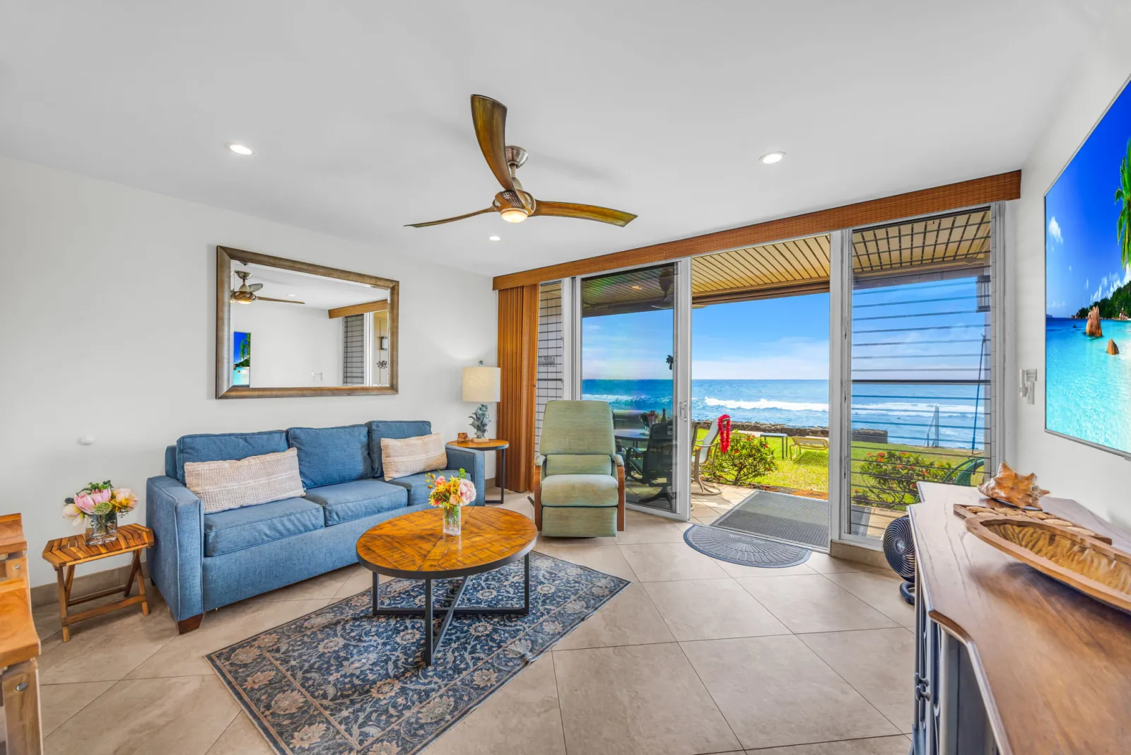Living room opening onto the lanai and the ocean beyond